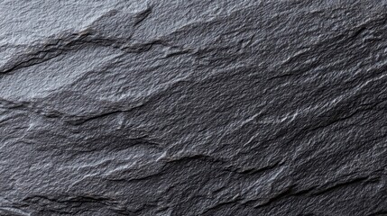 Textured black slate surface with natural stone pattern, showcasing minimalist elegance and raw beauty.