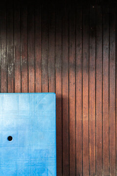Blue plastic table and dark wood floor, Chew Jetty, Malaysia