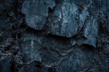 Close-up of a textured, weathered, dark blue wall surface