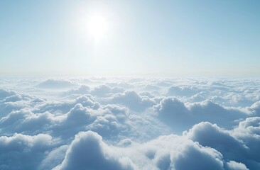 A vast expanse of fluffy white clouds stretches out beneath a bright, clear sky