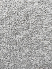 Close-up of soft grey terry cloth texture. The surface is composed of tiny looped fibers, providing...