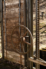 An old control mechanism overseeing the calm waters, showcasing the blend of nature and...