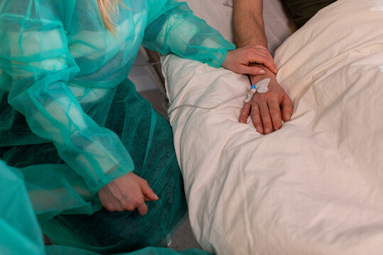 A dedicated healthcare professional is actively assisting a patient comfortably in their bed