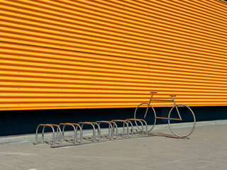 Vibrant yellow exterior of a modern industrial building with bike rack