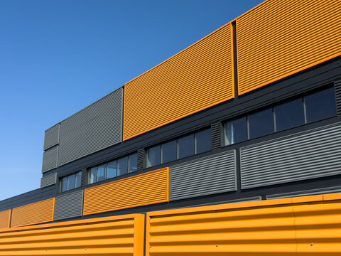Vibrant yellow and gray modern industrial building exterior