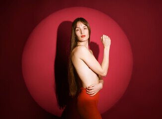 Studio portrait of a woman with a red circle backdrop