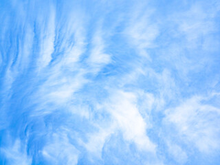 Blue sky with wispy white clouds in serene atmosphere