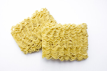 Instant noodle square, uncooked flat lay, isolated against white background.