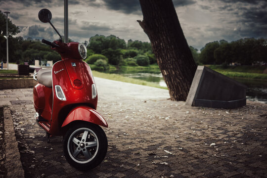 A red Vespa parked on the promenade
