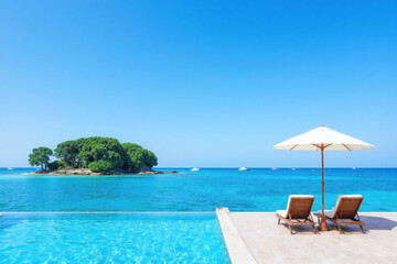 Obraz premium Two lounge chairs and an umbrella in the middle of a swimming pool