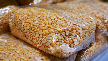 Close-up of many pea groats packages on a store shelf
