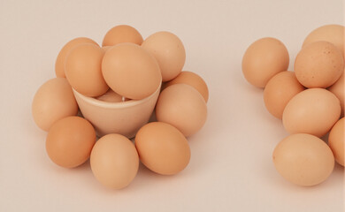 Fresh brown eggs in a circular pattern on white, symbolizing simplicity and natural harmony.
