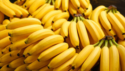 Fresh bunches of ripe, yellow bananas displayed close together. The vibrant bananas stand out with their vivid yellow color, highlighting their freshness and natural appeal.
