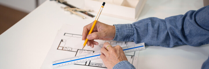 Architect Hand Drawing Blueprint with Pencil and Ruler for House Construction Design, adult architect creating blueprints, architect drawing for building plan