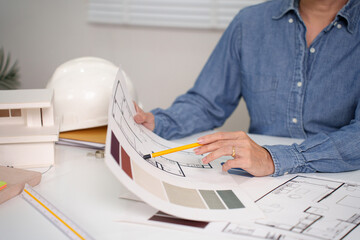 Adult Asian Hand Drawing Blueprint for House Project Architect Reviewing Blueprint Interior Design...