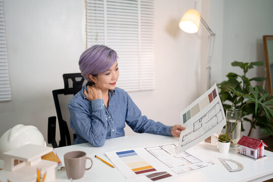 Asian woman architect design blueprint renovation concept review plan architectural older construction Asian woman interior studio