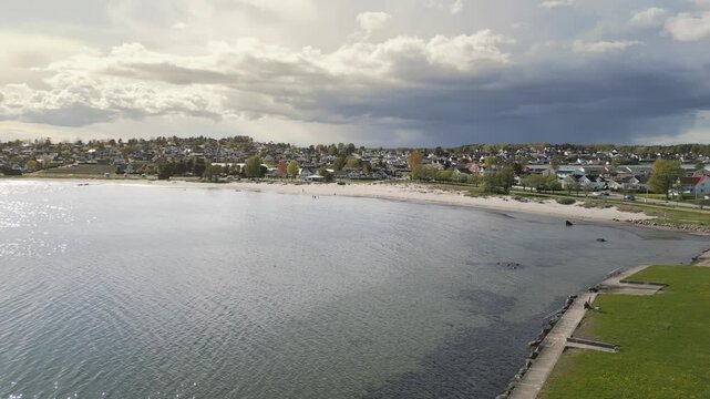 Aerial pan view Ringshaugstranda Beach under a cloudy sky, located near T&oslash;nsberg in Norway.