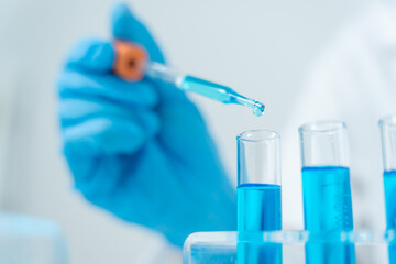 Fototapeta premium Scientist analyze biochemical samples in advanced scientific laboratory. Medical professional use dropper mix microbiological developmental of viral. Biotechnology research in science lab. cosmetic