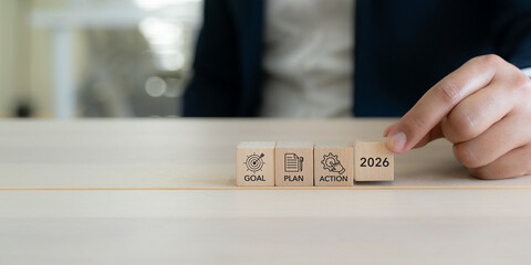 2026 Goal, plan, action, new year business strategic planning concept. Wooden blocks labeled "2026" "Goal" "Plan" and "Action" representing strategic progression toward success. Business motivation. © Parradee