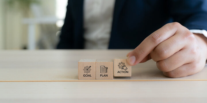 Goal, plan, action, business strategic planning concept. Wooden blocks labeled "Goal" "Plan" and "Action" representing strategic progression toward success. Business motivation and inspiration concept