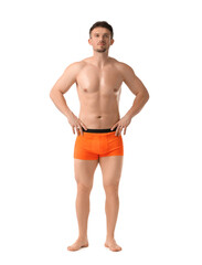 Young man in stylish orange underwear on white background
