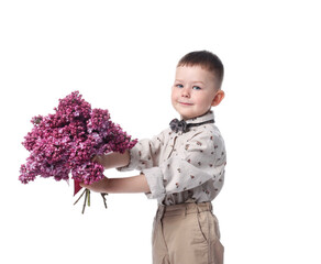 Little boy with bouquet of lilac flowers on white background