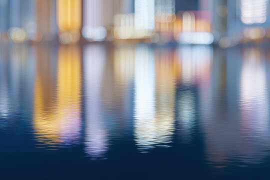 abstract representation of blurred reflections of modern city buildings in serene water body essence of urban life