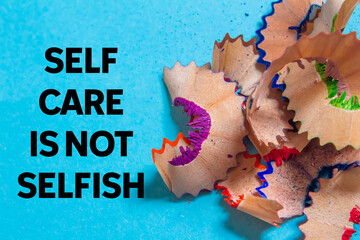 Self care is not selfish message written on blue background. Conceptual self care is not selfish...