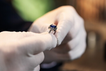 Appraiser working with luxury ring indoors, closeup