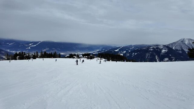 Salzburg, Austria: Point of view action footage of a snowboard that rides the slopes of the Snow Space Salzburg ski resort in the Austrian alps in winter. 