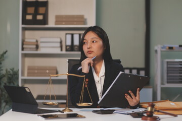 Judge gavel with Justice lawyers having team meeting at law firm background. Concepts of Law and...