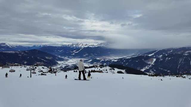 Salzburg, Austria: Point of view action footage of a snowboard that rides the slopes of the Snow Space Salzburg ski resort in the Austrian alps in winter. 
