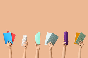 Naklejka na ściany i meble Female hands with different school supplies on beige background