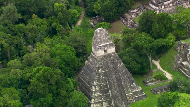 Stunning aerial videography of Tikal&rsquo;s ancient Mayan temple emerging from the dense jungle of Pet&eacute;n, Guatemala. A majestic archaeological site rich in history and surrounded by nature.