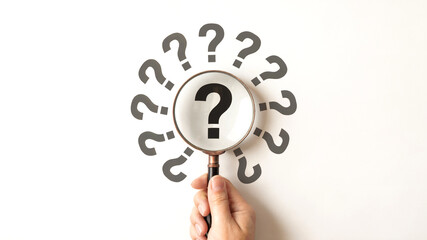 Hand Holding Magnifying Glass Over Question Mark