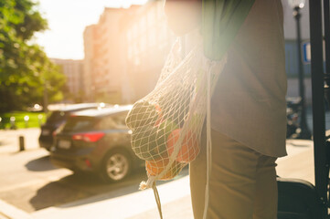 Indian businessman carries a reusable shopping bag filled with fresh produce, promoting sustainability and eco conscious consumerism