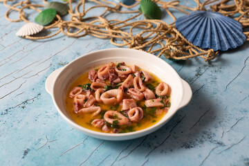 Tender calamari rings in lemony garlic parsley olive oil sauce.
