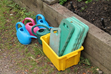 Plastic Kneeling Pads and Watering Cans for Gardening.