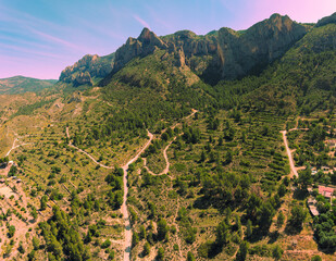 Panoramic view from above of valley and mountain ridge during sunrise. Coves del Canelobre near...