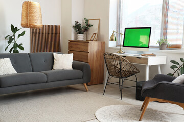 Interior of room with comfortable workplace and modern computer