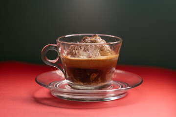 Affogato served in glass cup with whipped cream and espresso.