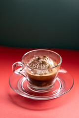 Affogato served in glass cup with whipped cream and espresso.