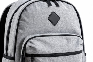 Fototapeta premium A close-up of a gray backpack with a distinctive leather patch on the front