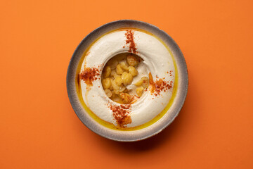 Smooth hummus topped with chickpeas, paprika, and olive oil.
