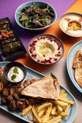 Colorful Lebanese mezze spread with moutabal, vine leaves, and bread.
