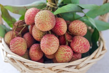 Lychee in the basket on grey background