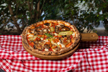 Wood-fired vegetable pizza topped with grilled zucchini, eggplant, and mushrooms.
