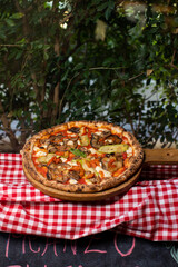 Wood-fired vegetable pizza topped with grilled zucchini, eggplant, and mushrooms.
