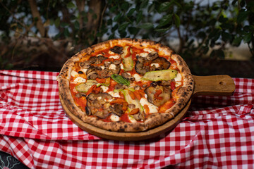 Wood-fired vegetable pizza topped with grilled zucchini, eggplant, and mushrooms.
