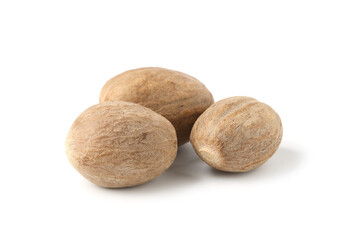 Three whole fresh nutmegs isolated on white